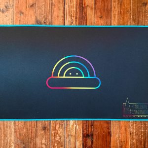 Blue Playmat on Table with Chasing Rainbows Logo and Inclusive Imagination Logo in Rainbow Gradient